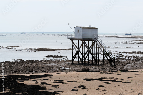 french sandy beach with isherman hut on the isle of Aix Charente maritime France photo