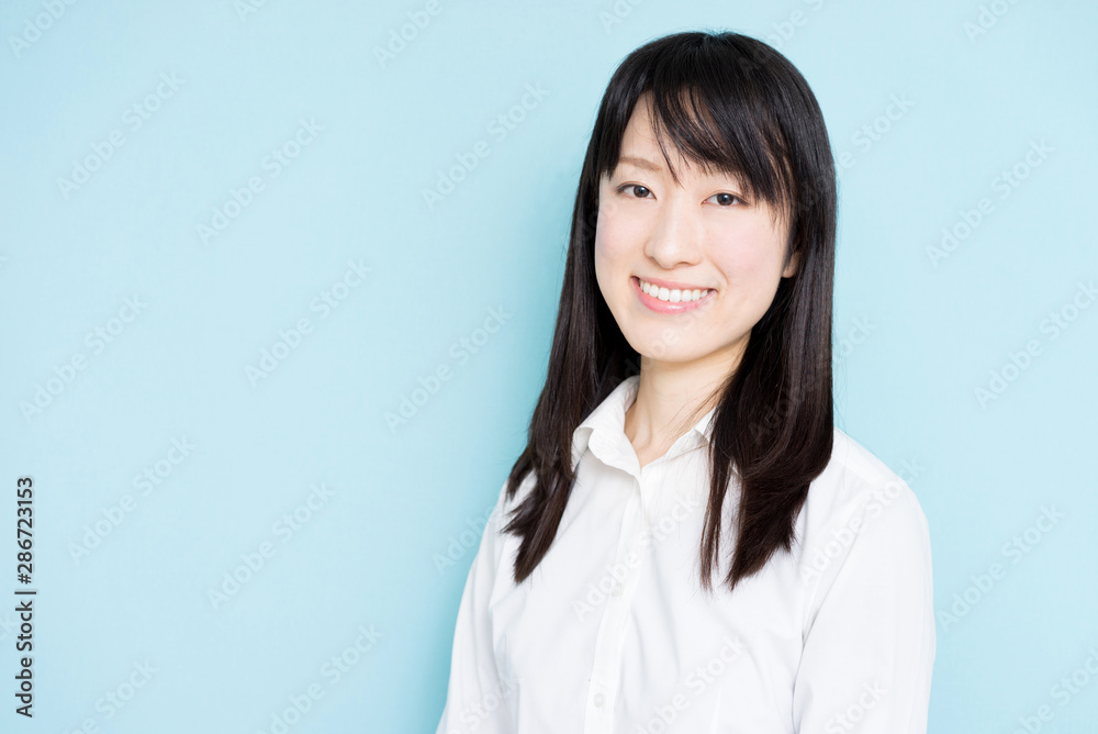 Happy business woman against light blue background