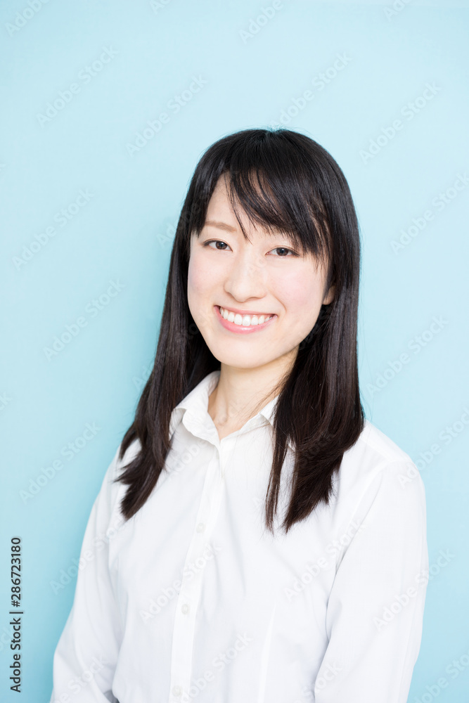 Happy business woman against light blue background