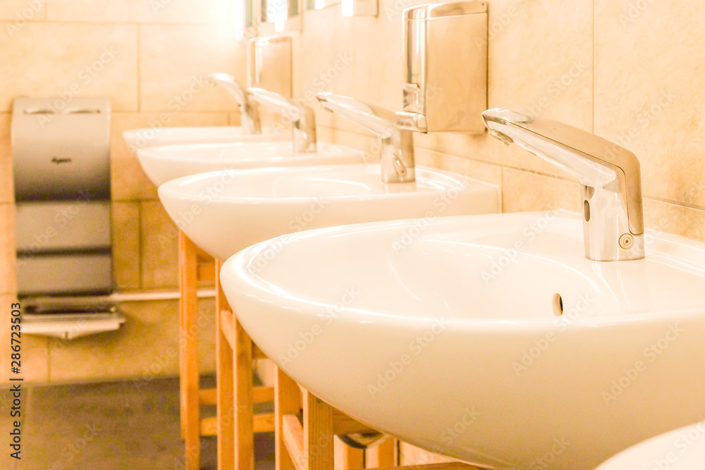 The sinks in a modern public rest room. The sinks in a modern public rest room.