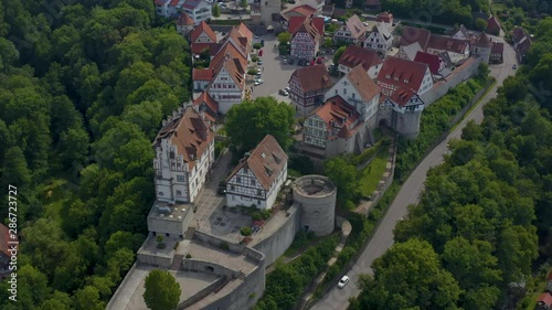 Aerial view of the village and castle Vellberg in Germany on a sunny day in spring. Zoom in on the front of the castle with fly over. photo