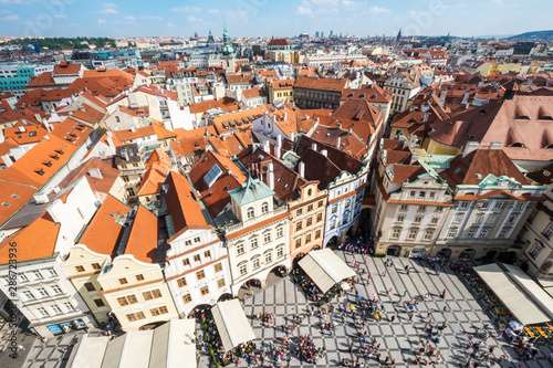 Old Town of Prague, Czech Republic. View on Tyn Church and Jan Hus Memorial on the square as seen from Old Town City Hall. Blue sunny sky