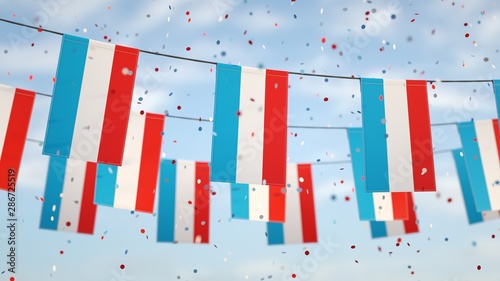 Vászonkép Luxembourgish flags in the sky with confetti.