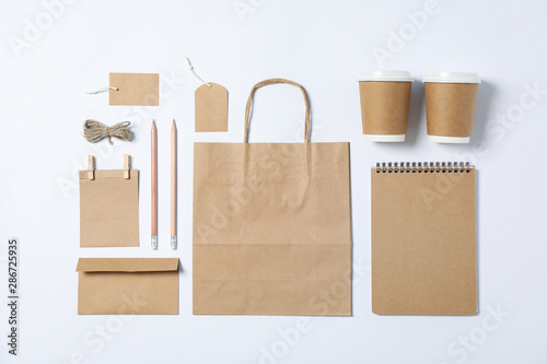 Fotografija Flat lay composition with blank stationery, paper cups and bag on white backgrou