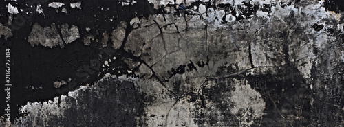 old black paint texture peeling off the concrete wall for dark theme banner background