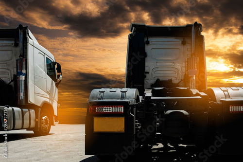 Semi TrailerTrucks Parked with The Sunset Sky. Shipping Trucks. Engine Diesel Trucks. Lorry Tractor. Industry Freight Trucks Logistics Cargo Transport.	