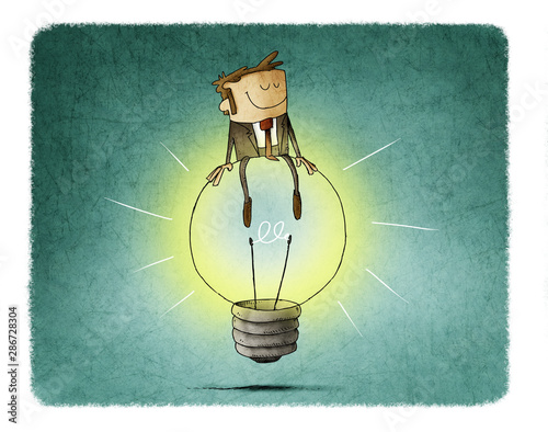 Cheerful man sitting on top of a big light bulb. idea and creativity concept.