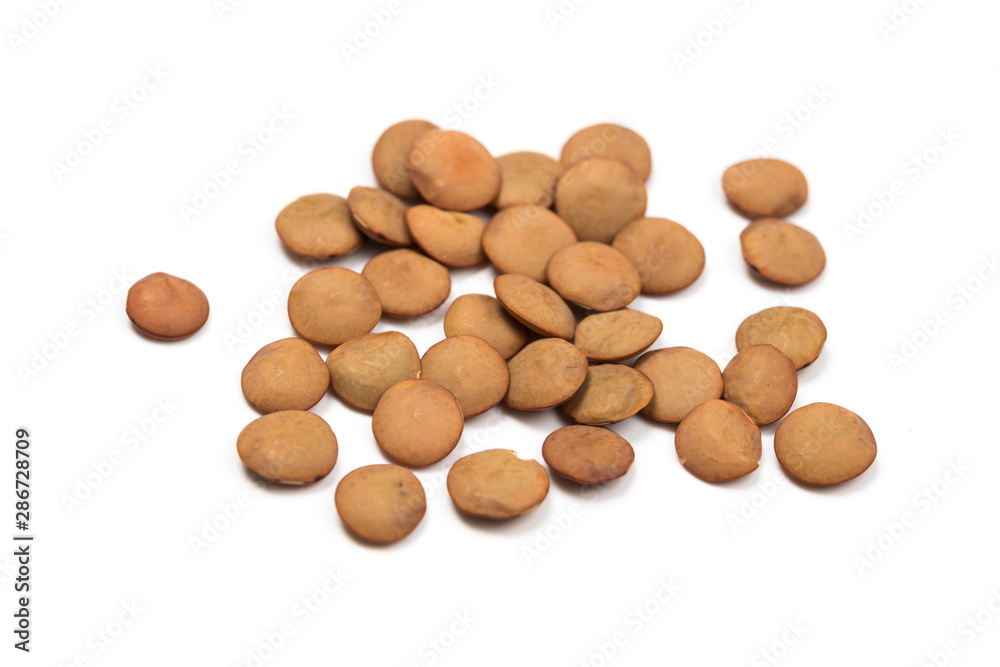 Isolated stack of uncooked lentils on white background from above. Isolated stack of uncooked lentils on white background from above.