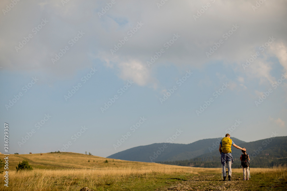 Young father and daughter enjoy hiking on a sunny day Young father and daughter enjoy hiking on a sunny day