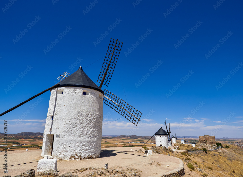 Old windmills and castle in the town of Consuegra, Spain Old windmills and castle in the town of Consuegra, Spain