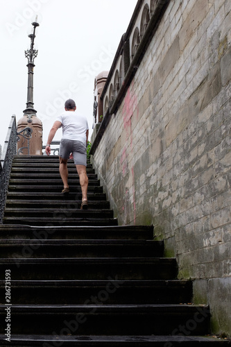 man climbing some stairs with a lot of slope