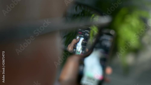 Businessman is checking Bitcoin price chart on digital exchange on mobile phone screen, cryptocurrency future price action prediction concept