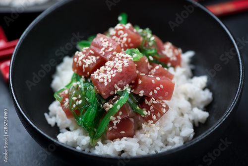 Close-up of a black bowl with hawaiian ahi poke, selective focus, studio shot