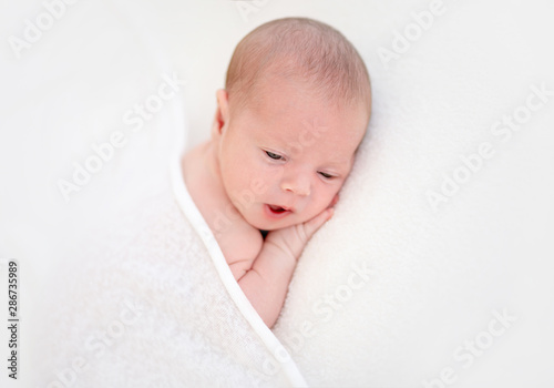 Closeup of cute newborn with eyes opened