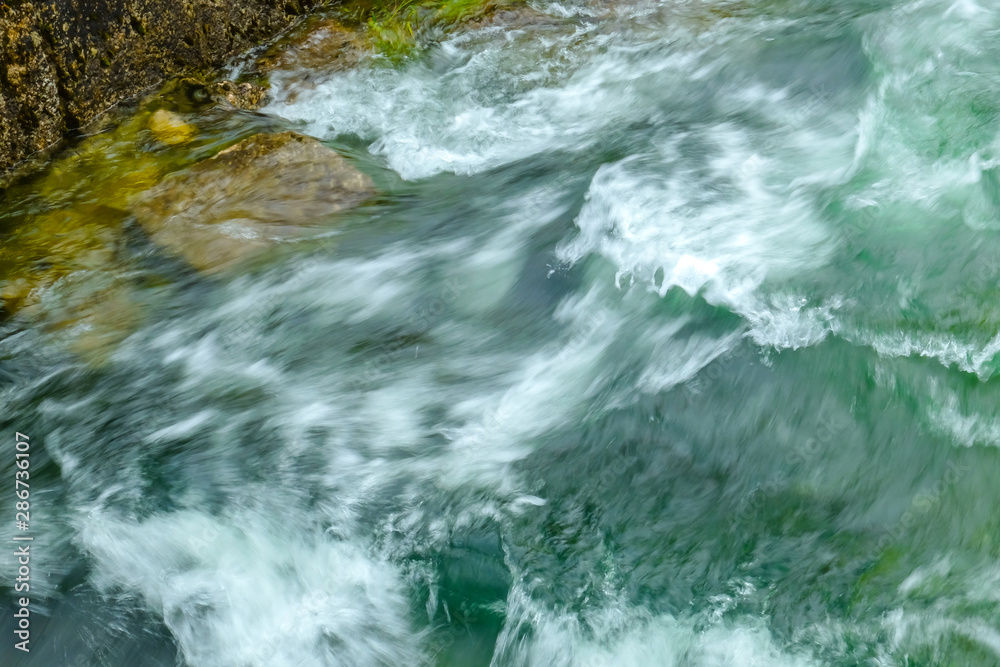 Flowing water stream with stones