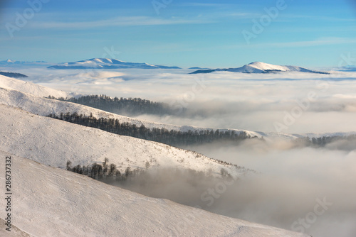 Winter Carpathians and fog at the bottom