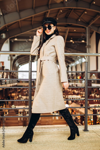 Fashion and trendy clothes. Black leather cap, coat and shoes. Autumn style. Interior photo. spring autumn collection. women's clothing business style office wear casual. Young sexy woman