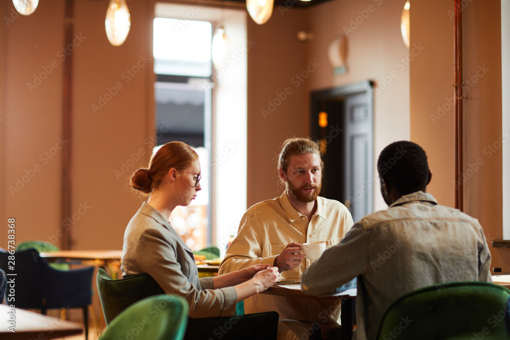 Group of young business people have business meeting in coffee shop they sitting and discussing future plans in team