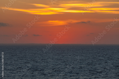 Orange sky right after sunset behind the italian coast