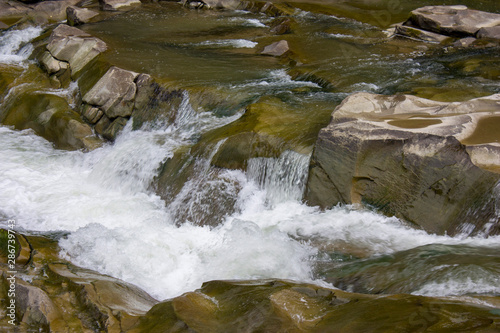 Mountain river in the summer with small waterfalls. Beautiful summer landscape of the Carpathians.