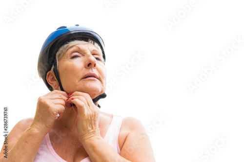 older sports woman wearing a bicycle helmet © Hector