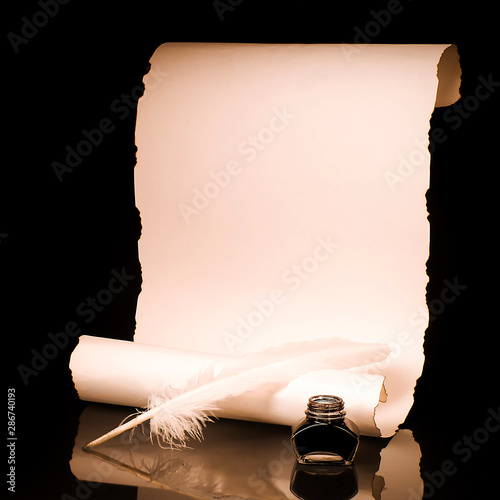 Unrolled papyrus scroll with inkwell and quill pen