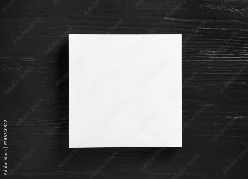 Stack of blank paper sheets for brochure on black wooden background, top view. Mock up Stack of blank paper sheets for brochure on black wooden background, top view. Mock up