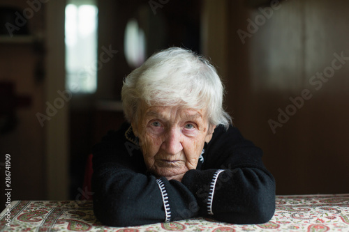 Portrait of a lonely with worried look elderly woman.