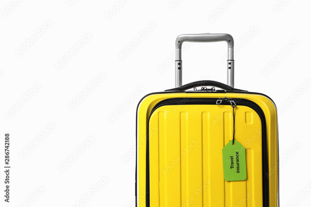 Yellow suitcase with TRAVEL INSURANCE label on white background Yellow suitcase with TRAVEL INSURANCE label on white background