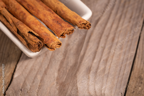 close up view of cinnamon sticks in a white pot