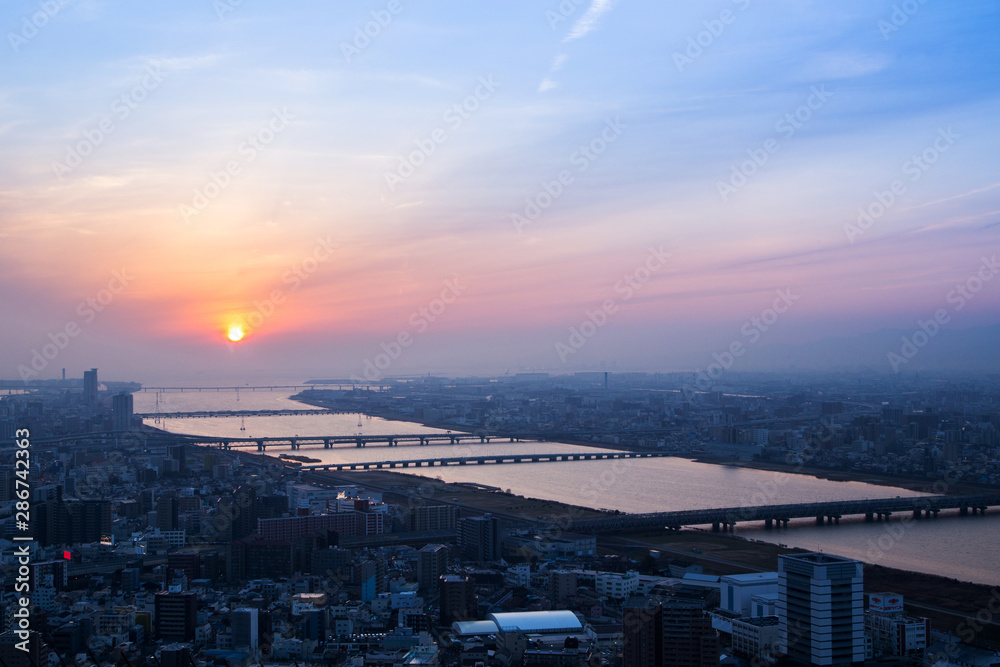 Beautiful Sunset sky over Osaka city and river aerial view, cityscape background