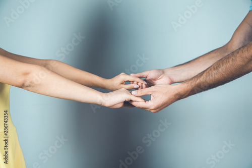 lovely man and woman hands on gray background