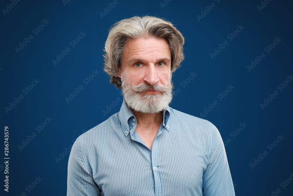 Portrait of handsome mature man on blue background Portrait of handsome mature man on blue background