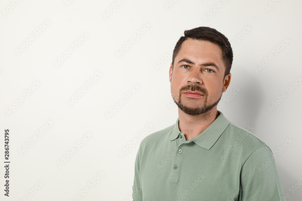 Portrait of handsome man on light background. Space for text Portrait of handsome man on light background. Space for text