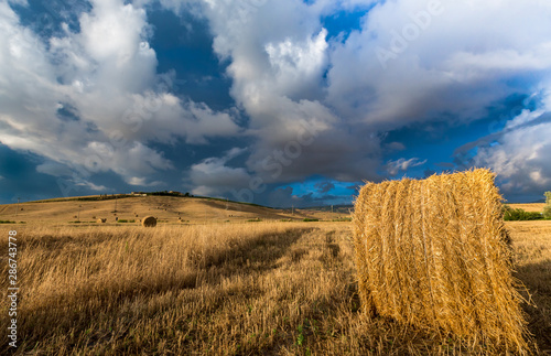 Summer storm looms over hay field in Tuscany  Italy.CR2
