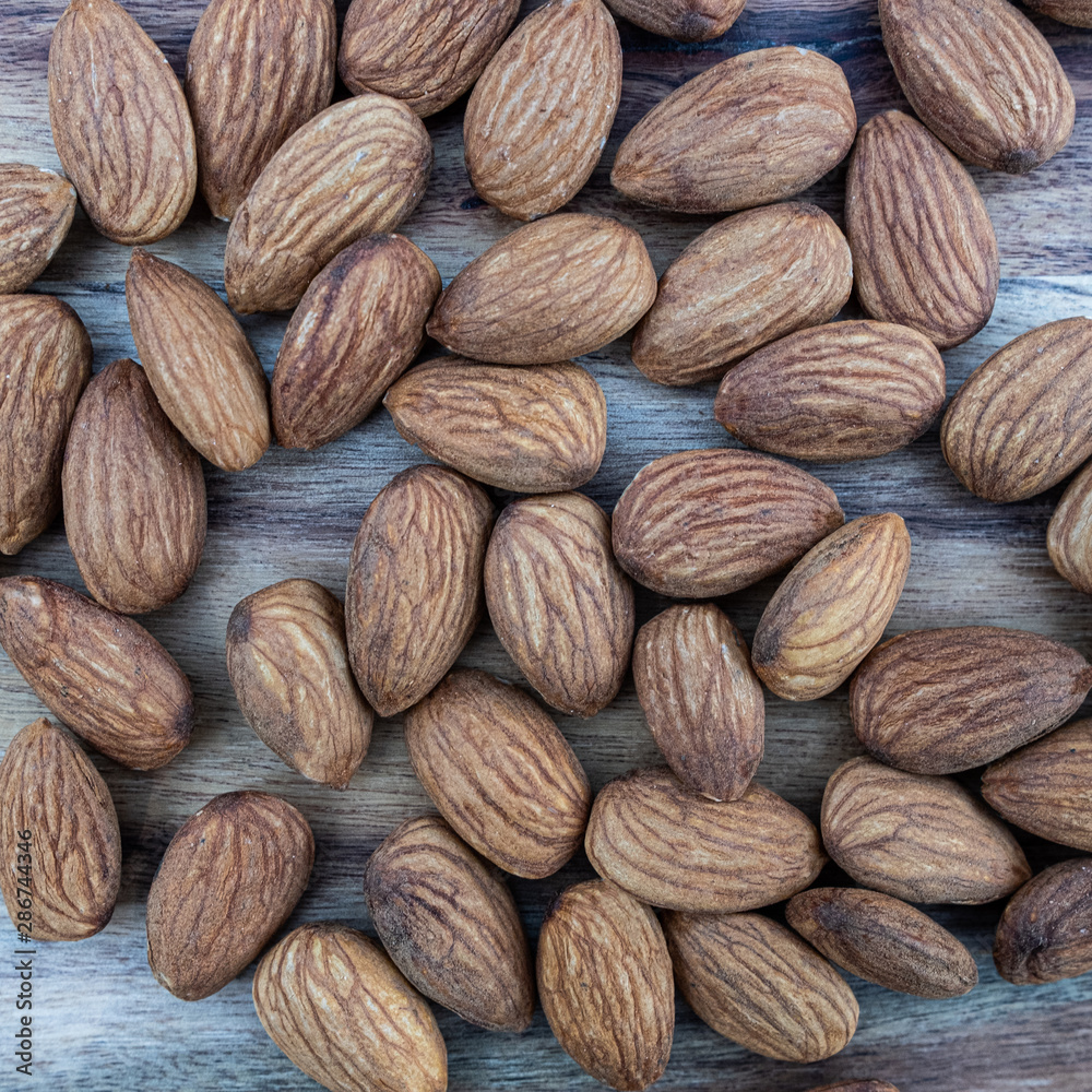 Fototapeta premium almonds on wooden background