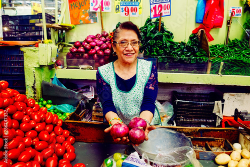Woman showing onions in market