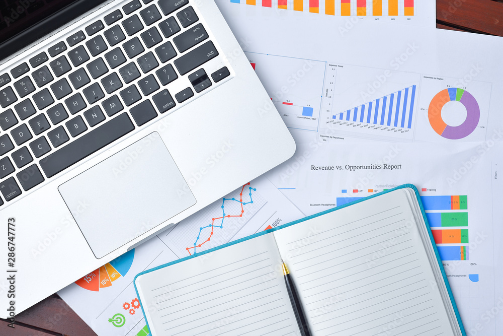 Business and Finances Concepts. Laptop, Notebook with graph and pen