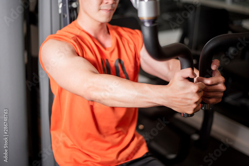 Asian man is working out  in fitness gym © tonefotografia