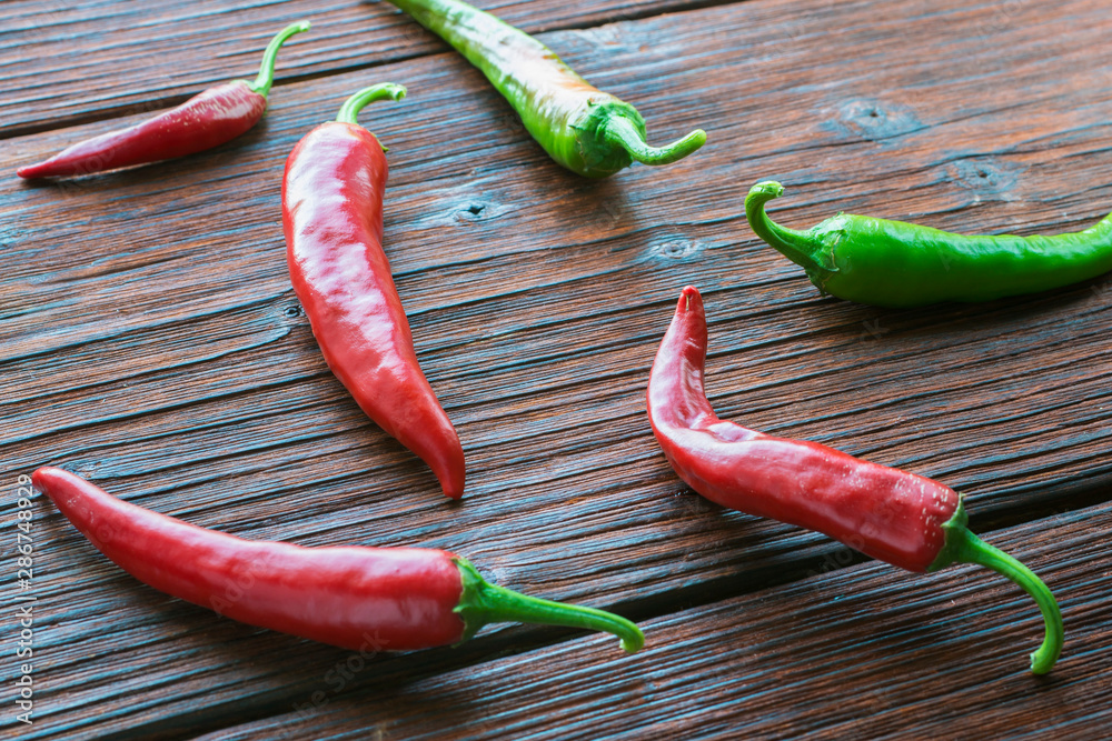 Hot pepper pods on a wooden table. Hot pepper pods on a wooden table.