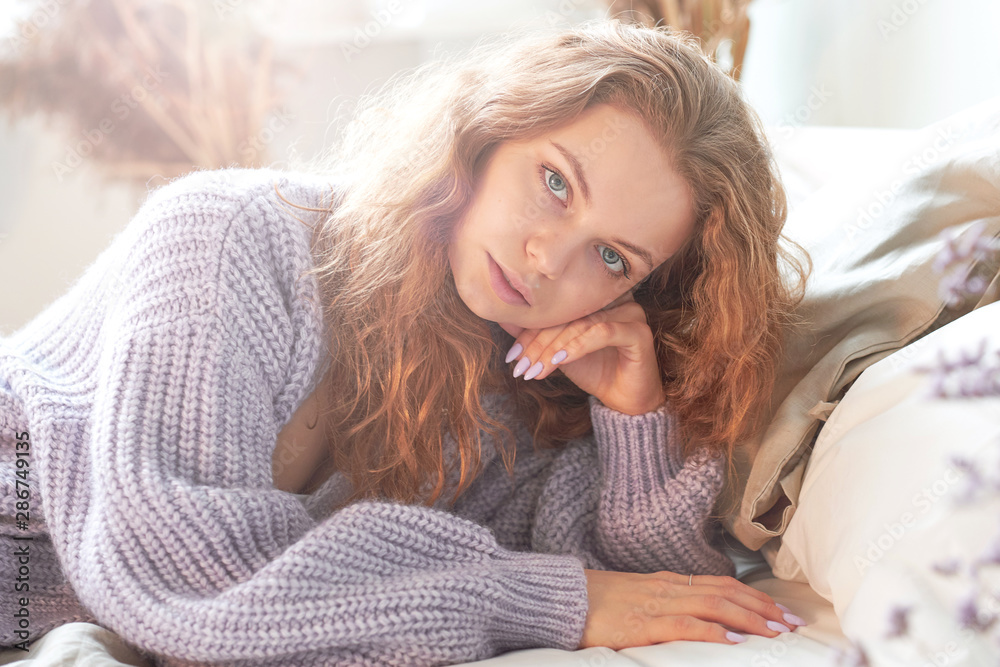 red-haired girl stretches into bed. wake up early in the morning, lazy weekend. red-haired girl stretches into bed. wake up early in the morning, lazy weekend.