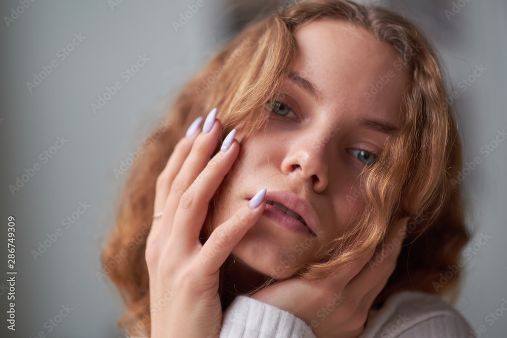 portrait of a beautiful curly girl. the mysterious face of a woman at the window. portrait of a beautiful curly girl. the mysterious face of a woman at the window.