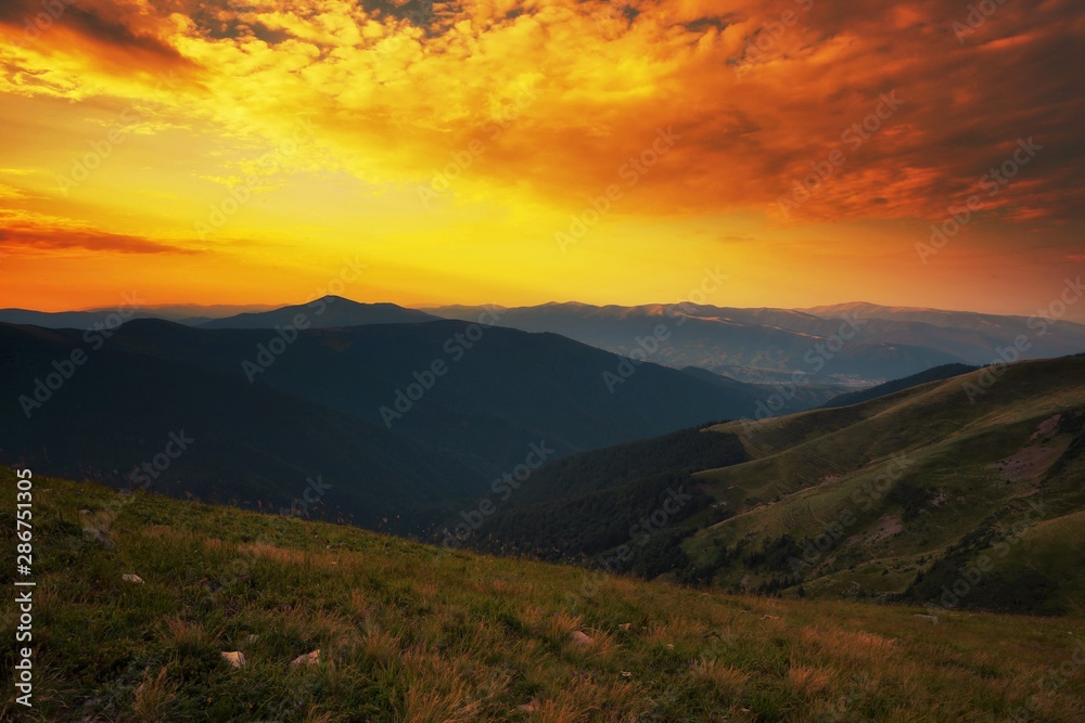 colorful summer sunrise image, picturesque morning dawn view on meadow on hill and valley, red yellow dawn sky, Europe, Carpathians, Ukraine, discover yoursel wonderful place