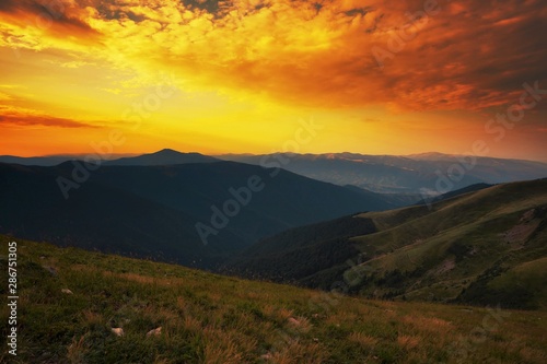 colorful summer sunrise image, picturesque morning dawn view on meadow on hill and valley, red yellow dawn sky, Europe, Carpathians, Ukraine, discover yoursel wonderful place