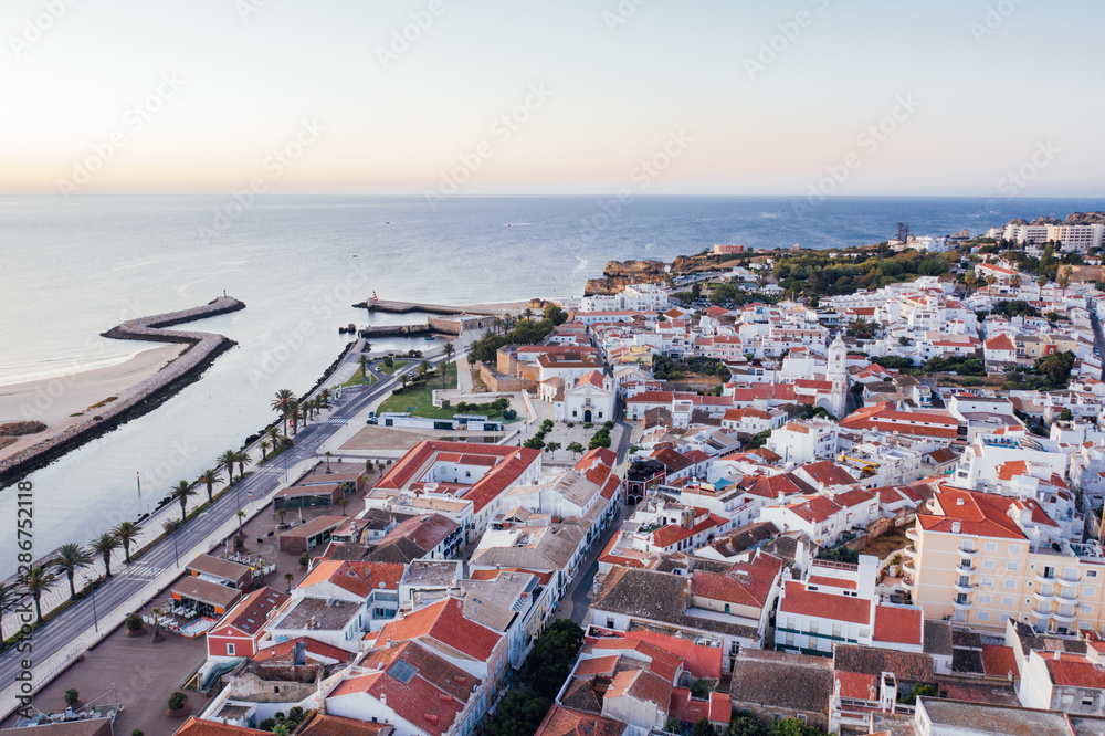 Aerial drone view of central part and marina of Lagos, Algarve, Portugal at morning
