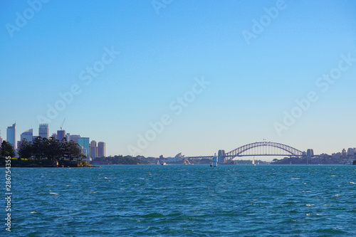 Australia sydney city CBD view from Cremorne point over blue harbour waters under clear sky