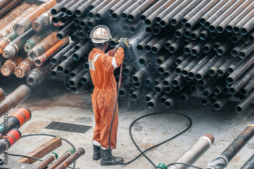 Employee cleaning upper rods
