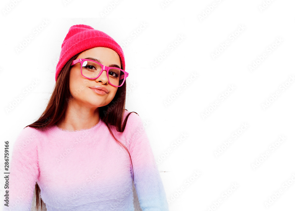 pretty young teenage girl hipster in pink glasses and hat emotional posing happy smiling, lifestyle people concept