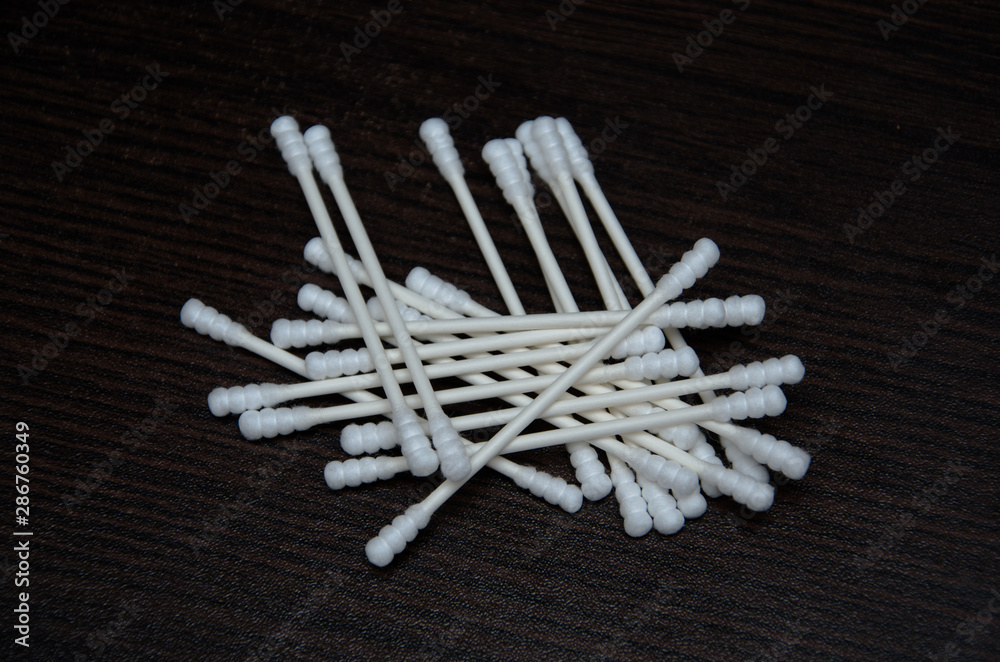 Stack of cotton buds on black background. Healthcare concept