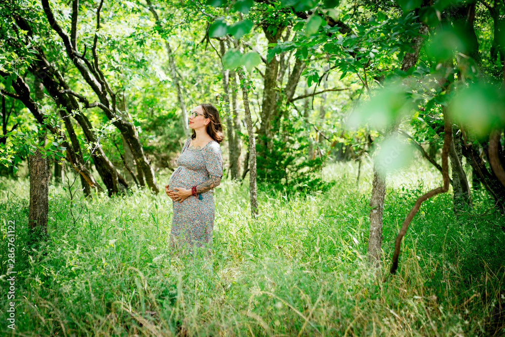 Side view of pregnant woman in forest Side view of pregnant woman in forest